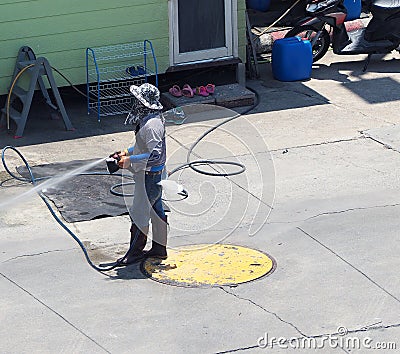 Washing car by worker who standing outdoor. Stock Photo