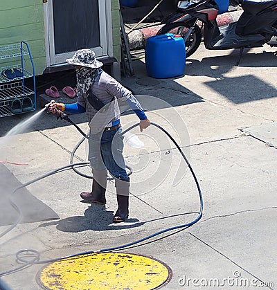 Washing car by worker who standing outdoor. Stock Photo