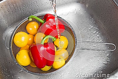 Washing colorful fruits and vegetables Stock Photo