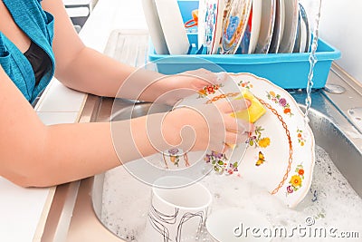 Washing the dishes on the kitchen sink Stock Photo