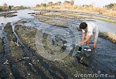 Washing in drying river Editorial Stock Photo