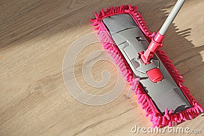 Washing Dust on Wooden Floor with Mop Stock Photo