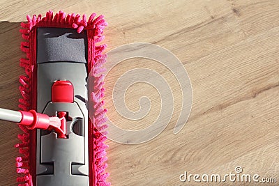 Washing Dust on Wooden Floor with Mop Stock Photo