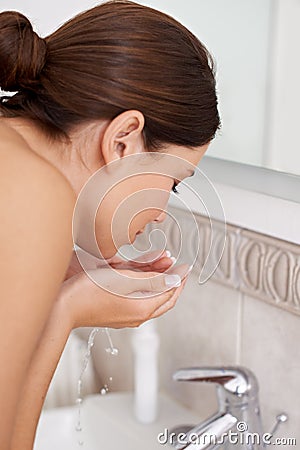 Washing, face and woman with water in bathroom for skincare, routine and self care in morning. Dermatology, beauty and Stock Photo