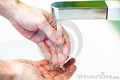 Washing hand under tap water Stock Photo
