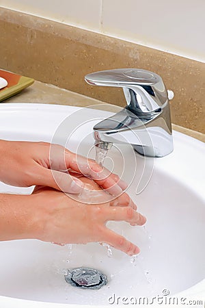 Washing hands in sink. Stock Photo