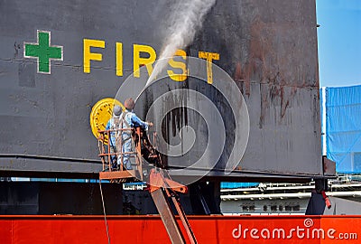 Washing at hatch cover ship and cleaning of Cargo ship in floating dock by high pressure water jet Stock Photo