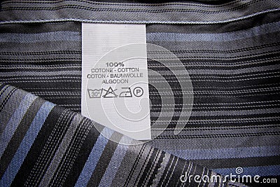 Washing instruction label on cotton vertical stripes shirt Stock Photo