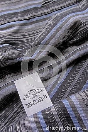 Washing instruction label on cotton vertical stripes shirt Stock Photo