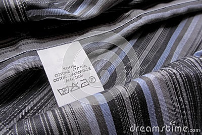 Washing instruction label on cotton vertical stripes shirt Stock Photo