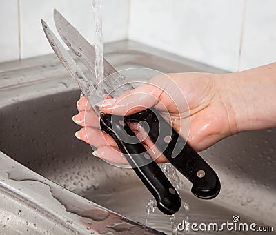 Washing of the knives Stock Photo