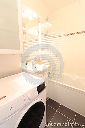 Washing machine in bathroom. Nice bathtub Editorial Stock Photo