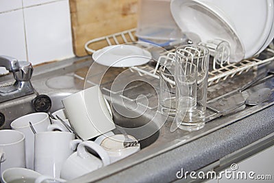 Washing-up in office kitchen sink Stock Photo