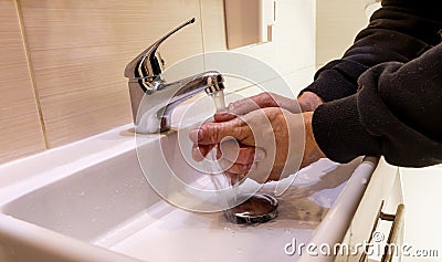 Washing your hands at the sink removes bacteria and viruses from hands Stock Photo