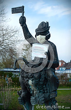 Wasserburg, Germany - 2020, April 17: Monument with mask for covid-19. Stay at home protest Editorial Stock Photo