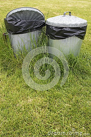 Waste bins in grass Stock Photo