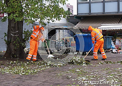 Waste collectors collecting leaves in Hamburg Editorial Stock Photo