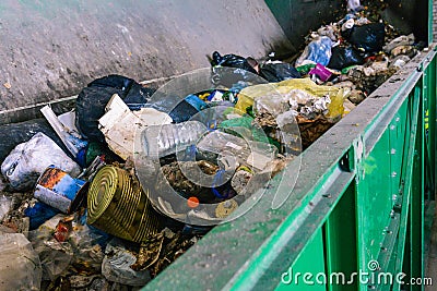 Waste container on the sorting line of a recycling plant. The process of separating garbage in a container. Packages Stock Photo