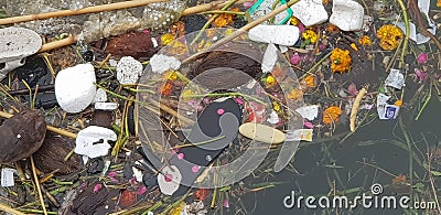 Waste material moving with canal water in India Editorial Stock Photo