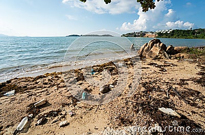 Waste on the sands causes environmental pollution. Trash on beach. Beach pollution. Plastic bottles and other trash on Stock Photo