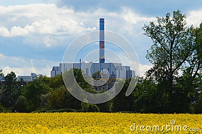 Waste-to-energy plant behind a rapeseed field in Frankfurt Editorial Stock Photo