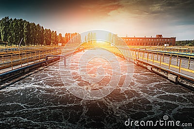 Wastewater treatment plant at sunset. Tanks for aeration and cleaning of sewage mass Stock Photo