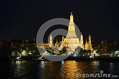 Wat Arun temple at night time with glitter light on the water Stock Photo