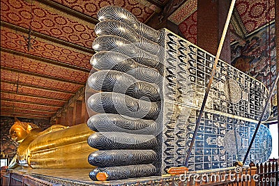 The massive gold gilded Reclining Buddha image at Wat Pho, Bangkok, seen here from the base of the statue Stock Photo