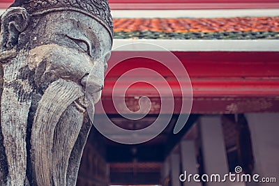 Wat Pho smiling chinese monk stone statue. Bangkok, Thailand. Stock Photo