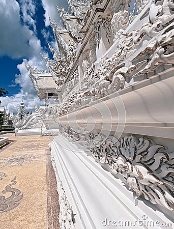 Wat Rong Khun decorative railing and roofs side view Stock Photo