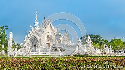 Wat Rong Khun The White Abstract Temple and pond with fish, in Chiang Rai, Thailand. Popular and famous Stock Photo