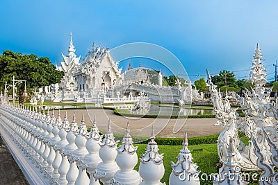 Wat Rong Khun The White Abstract Temple and pond with fish, in Chiang Rai, Thailand. Stock Photo