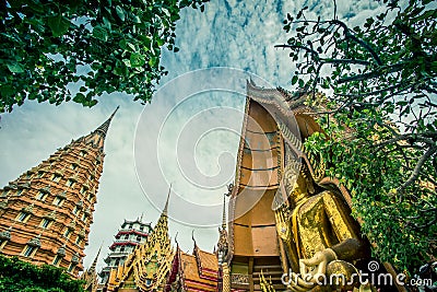 Octagonal pagoda,Chinese Pagoda,Vihara and large golden Buddha statue at Wat Tham SuaTiger Cave Temple,Tha Muang District,Kancha Stock Photo