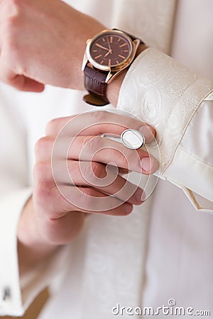 Watch and cuff link on the groom's hand Stock Photo