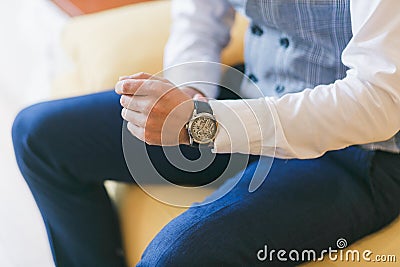 Watch on man`s hand. Groom preparing for wedding ceremony. Close-up shot Stock Photo