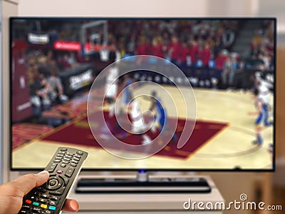 Watching basketball game on TV Stock Photo