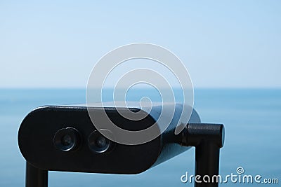 Watching the Black Sea through a binocular telescope. Travel and tourism. Coin binoculars Stock Photo