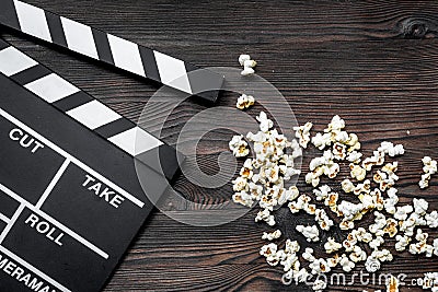 Watching the film. Movie clapperboard and popcorn on wooden table background top view copyspace Stock Photo