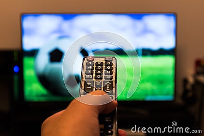 Watching soccer / football game on modern tv, with a close-up of Stock Photo