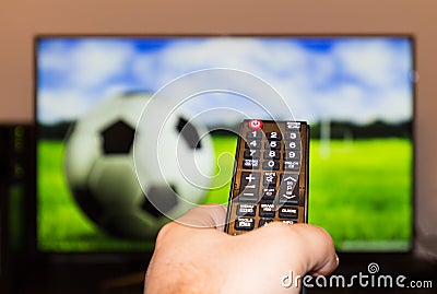 Watching soccer / football game on modern tv, with a close-up of Stock Photo