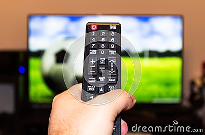 Watching soccer / football game on modern tv, with a close-up of Stock Photo