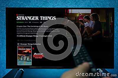 Watching Stranger Things television show on TV. Stranger Things is an American science fiction horror drama television series Editorial Stock Photo