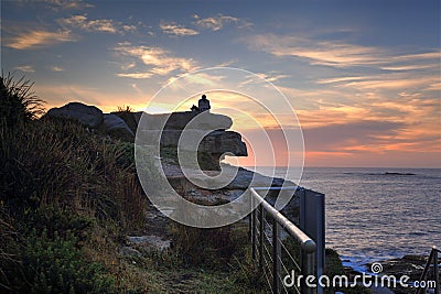 Watching sunrise at Coogee Beach Australia Stock Photo