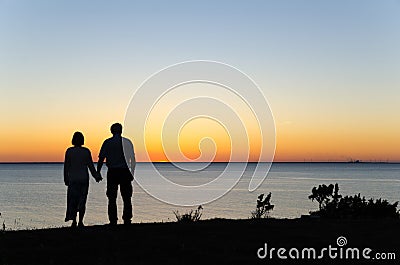 Watching sunset hand in hand Stock Photo