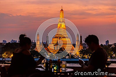 Watching the sunset at Wat Arun from Amorosa Bar Stock Photo