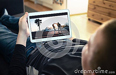 Watching VOD service and online movie stream. On demand film streaming, tv series or music video in smart device screen. Stock Photo