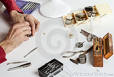 The watchmaker is repairing the mechanical watch. Tools for repairing mechanical watches Stock Photo