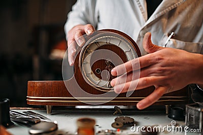 Watchmaker restore old wooden table clock Stock Photo