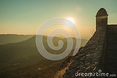 Watchtower and stone wall over rocky cliff in Marvao Stock Photo