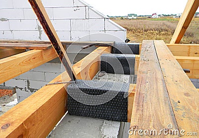 Wateproofing house roof wooden beams, trusses with bitumen material. House roofing construction Stock Photo